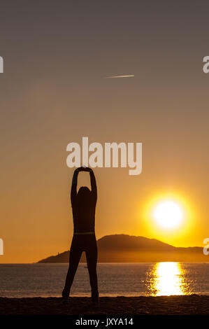 In Argeles-sur-Mer (Frankreich). Junge Frau, die sich direkt am Meer, in den frühen Morgenstunden Stockfoto