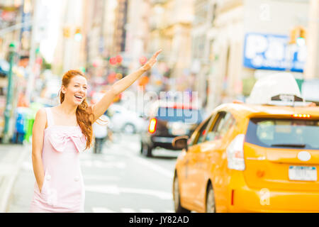 Eine junge Frau, ein gelbes Taxi beim Gehen auf einer Straße in New York City Stockfoto