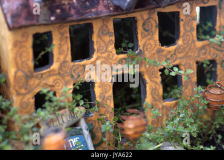 Gelb Keramik Märchen Haus in einem grünen Garten Stockfoto