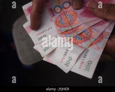 100 Chinesische Yuan Noten werden gezählt und schwärmten aus, Stockfoto