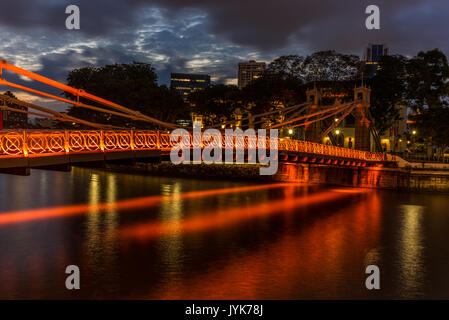 Alte hell erleuchtete Brücke auf dem Singapore River bei Sonnenuntergang - 2 Stockfoto