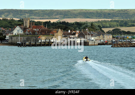 Nähert sich Yarmouth Isle of Wight auf dem Seeweg durch eine Fähre mit einem kleinen Boot oder Steg im Vordergrund verschiedene alternative Ansicht von Yarmouth Isle of Wight Stockfoto