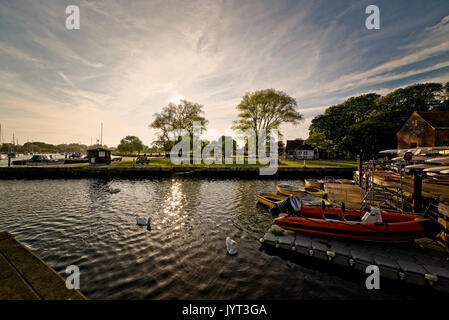 Annäherung an den Sonnenuntergang über dem quamps und Christchurch quay Dorset Stockfoto