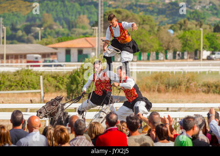 Sardinien Reiten, ein 3 Mann Team eine traditionelle Reiten Meisterstück im Ippodrome Rennstrecke während der cavalcata Festival in Sassari durchführen. Stockfoto