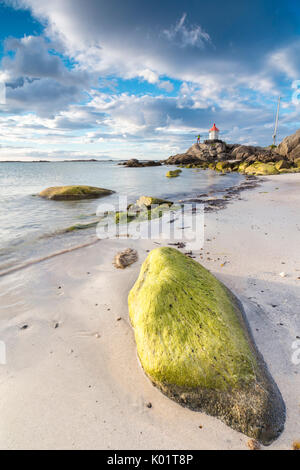 Midnight Sun leuchtet auf Felsen und Sandstrand umgeben von türkisblauem Meer Eggum Unstad Vestvagøy Lofoten Inseln Norwegen Europa Stockfoto