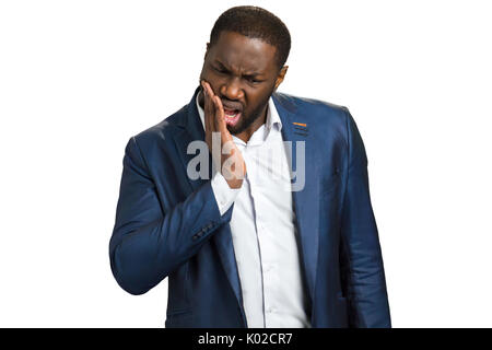 Junge Unternehmer leiden unter Zahnschmerzen. Junger Mann sein Gesicht zu berühren und Zahnschmerzen fühlen. Tooth ache Konzept. Stockfoto