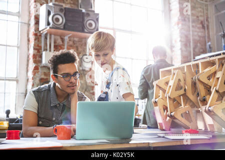 Ernst, konzentrierte sich Designer auf Laptop Arbeiten in der Werkstatt Stockfoto