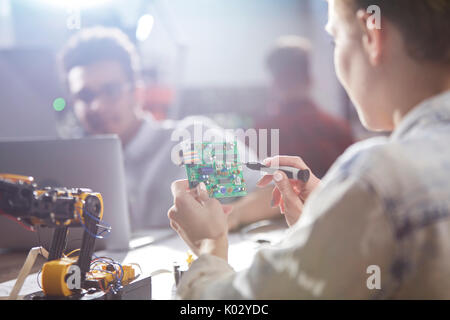 Ingenieurin Montage Platine mit Lötkolben Stockfoto