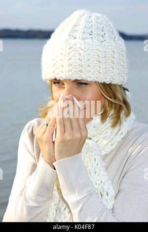 Hübsche blonde Frau mittleren Alters in einem Herbst Spaziergang an einem See. Stockfoto
