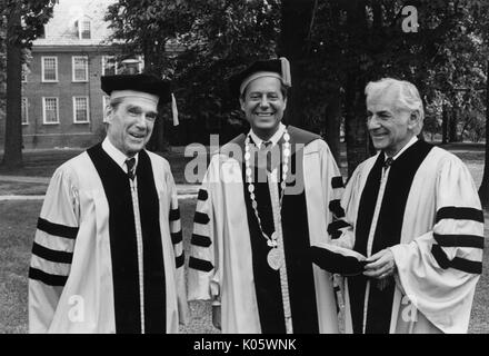 Halbe Körper Portrait von drei Männer an 1980 Johns Hopkins Beginn, alle in Gap und Kleid Kleidung, von Links nach Rechts: Professor Daniel K Ludwig, Präsident Steven Muller, und Musiker Leonard Bernstein, der seinen Hut genommen hat und die beiden anderen die Aufmerksamkeit auf ihn zu, 1980 erstellt. Stockfoto