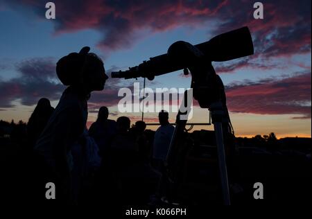 Ein Teilnehmer eines Star Party sieht durch ein Teleskop in die Sonne am Abend vor der totalen Sonnenfinsternis vom 20. August 2017 in Madras, Oregon. Die Eclipse wird über einem schmalen Teil der aneinandergrenzenden Staaten der USA von der Lincoln Beach, Oregon fegen werden nach Charleston, South Carolina am 21. August 2017. Stockfoto