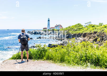 Zurück der Mann Fotograf aufnahmen auf Stativ von Portland Head Lighthouse in Fort Williams Park in Maine im Sommer Tag Stockfoto