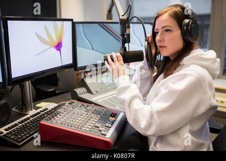 Host einstellen Kopfhörer und Mikrofon am Tisch in Radio Studi Stockfoto