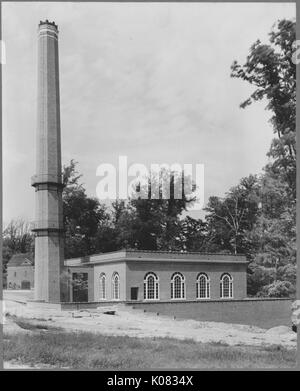 1-stöckiges Gebäude mit Bogenfenstern, einem großen zylindrischen Konstruktion, vielleicht ein Wachturm, Bäume um den Bau; Roland Park/Guilford, 1910. Dieses Bild wird von einer Reihe dokumentieren den Bau und den Verkauf von Wohnungen in der Roland Park/Guilford Nachbarschaft von Baltimore, einer Straßenbahn Vorort und eines der ersten geplanten Gemeinschaften in den Vereinigten Staaten. Stockfoto