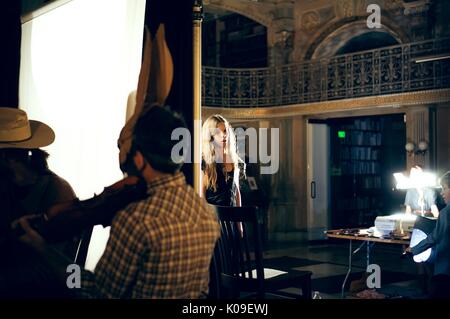 Eine Studentin im Peabody Library hinter einem weißen Bildschirm mit anderen Studenten vor, 2015 stehen. Stockfoto