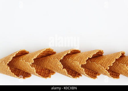 Mehrere Waffelkegeln mit Turm, Lächeln oder sogar Reihe, Draufsicht, isoliert auf weißem Hintergrund gefüttert. Stockfoto