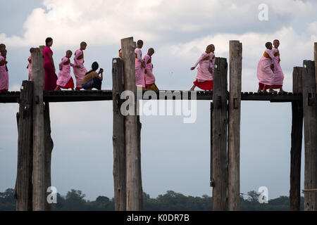 Frauen Mönche überqueren Sie die U-Bein Brücke am Abend, Mandalay, Myanmar Stockfoto