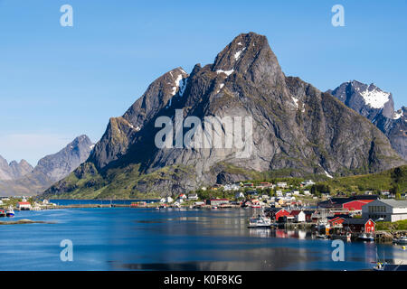 Blick über die natürliche Fischerhafen zu hoch aufragenden Bergen über Reine, Moskenes, Insel Moskenesøya, Lofoten, Norwegen Stockfoto
