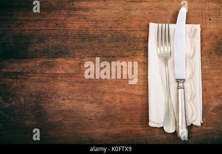 Tisch mit Messer und Gabel auf hölzernen Hintergrund Stockfoto