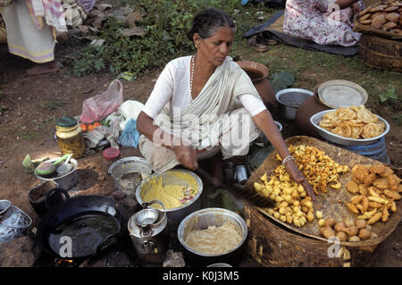 Dongria Kondh Frau Kochen am Wochenmarkt, Bissamcuttack, Odisha (Orissa), Indien Stockfoto