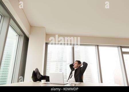 Geschäftsmann entspannen im Büro mit Füßen auf Schreibtisch, Copyspace Stockfoto