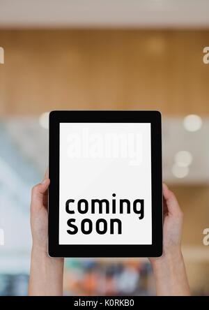 Digital composite Business woman holding eine Tablette, die bald kommenden Text Stockfoto