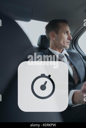 Digital composite von Symbol Uhr gegen Mann im Auto Stockfoto