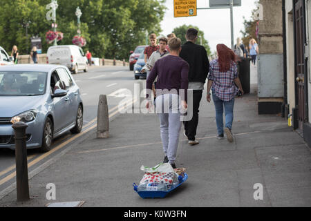 Bridge Street, Caversham, Reading, Berkshire, Großbritannien. 25 Aug, 2017. Ein Mann mit einem Schlitten voller Taschen und Wasser bereit für Reading Festival Credit: Brian Southam/Alamy leben Nachrichten Stockfoto