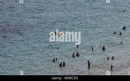 Touristen schwimmen oder genießen Sie maritimen Tätigkeiten, wie sie in den Strand von Magaluf in der spanischen Baleareninsel Mallorca sunbatthe Stockfoto