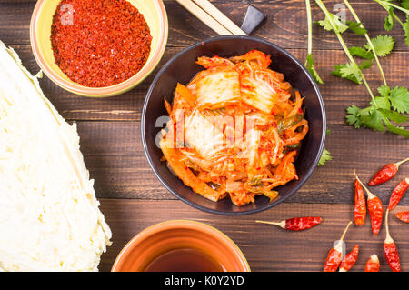 Kimchi - Koreanische superfood. Eingelegte Chinakohl in Schale auf Holztisch Stockfoto