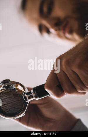 Man grooming frisch gemahlenen Kaffee in einen bodenlosen portafilter Stockfoto