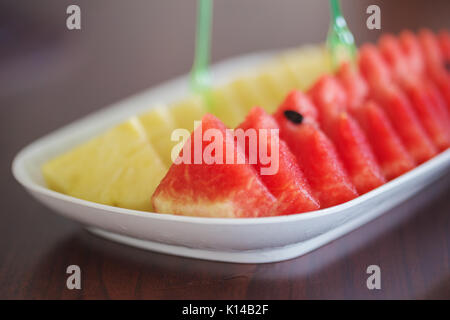 Scheiben von Wassermelonen und Ananas auf ein Holz Tisch Stockfoto