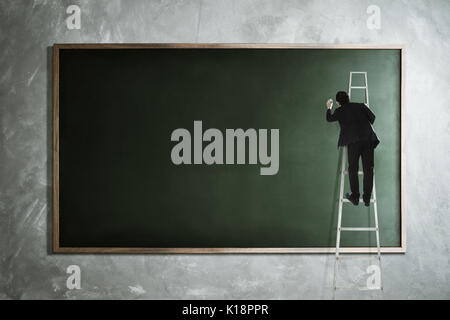 Männer Zeichnung auf leere Tafel. Stockfoto