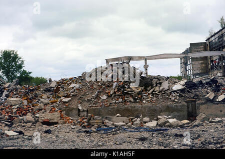 Das fabrikgebäude und der Straße nach Beschuss zerstört. Der Berg von Schutt Stockfoto