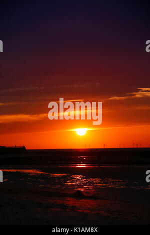 Technicolor Sonnenuntergang über Thanet windfarm Stockfoto