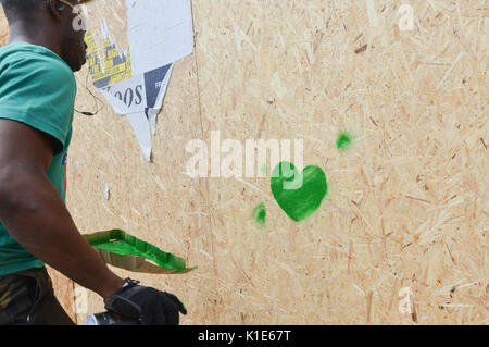 Westbourne Grove, London, UK. 26 Aug, 2017. Ein Mann (eine von vielen sagte Er) Spritzen der Grünen grüne Herzen Grenfell' auf der Geschäfte entlang der Karneval Route bestiegen werden. Quelle: Matthew Chattle/Alamy leben Nachrichten Stockfoto