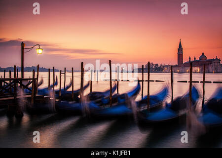 Sinrise über die Gondeln in Venedig, Italien und die Insel San Giorgio Maggiore. Stockfoto