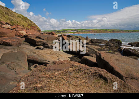 Die sandsteinfelsen von St. Bees Head mit st Bienen Dorf in der Ferne Stockfoto