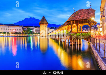 Luzern, Schweiz. Das historische Stadtzentrum mit seinen berühmten Kapellbrücke und Mt. Pilatus im Hintergrund. (Floralpina), Stockfoto