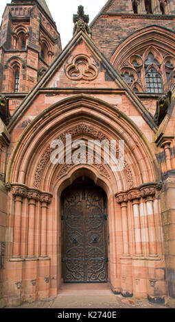 Gewölbten Tür mit riesigen & verzierten Scharniere in imposanten steinernen Torbogen am Eingang der historischen Thomas Mäntel Memorial Baptist Church in Paisley, Schottland Stockfoto