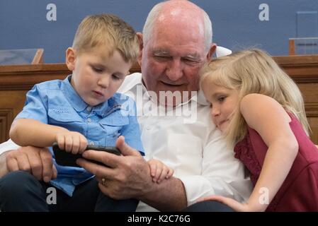 Us-Landwirtschaftsminister Sonny Perdue nimmt eine Auszeit von seinem ersten Tag auf dem Job mit seinen Enkelkindern im Landwirtschaftsministerium der USA Hauptsitz am 25. April 2017 in Washington, DC zu spielen. Stockfoto
