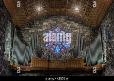 Galway, Irland - August 5, 2017: Nahaufnahme von grauen Rohre und braunes Holz Form der Orgelempore der Kathedrale. Hintergrund der Hexagon befleckte Fenster und Stockfoto