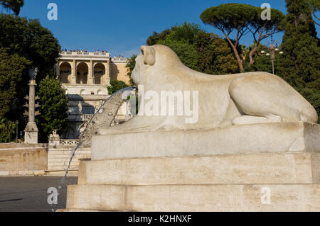 Lion Skulptur an der Piazza del Popolo mit dem Pincio im Hintergrund, Rom, Italien Stockfoto