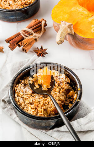 Diätetische herbst Gebäck, Frühstück. Crumble Pumpkin Pie, Ahornsirup und Haferflocken Flocken, in Teller Untertassen, auf weissem Marmortisch. Platz kopieren Stockfoto