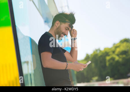Profil Portrait von glücklichen Menschen außerhalb Holding mobile Stockfoto