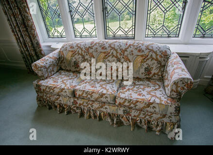 Eine reich verzierte Sofa am 67 Zimmer Coe Halle an der Bepflanzung Felder Arboretum in Oyster Bay, Long Island, New York. Stockfoto