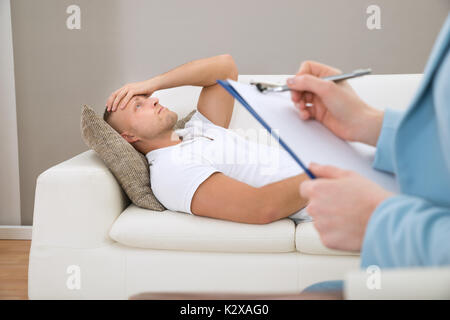 Nahaufnahme der Psychiater Schreiben auf Zwischenablage Vor Patienten Stockfoto