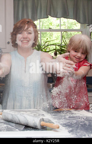 Mutter und Tochter Spaß spielen mit Mehl in der Küche. Stockfoto