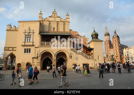 Touristen Spaziergang durch Rynek Glowny, der Hauptplatz in der Altstadt von Krakau, Polen, am 25. August 2017. Die Tuchhallen ist in der Mitte, mit St. Ma Stockfoto