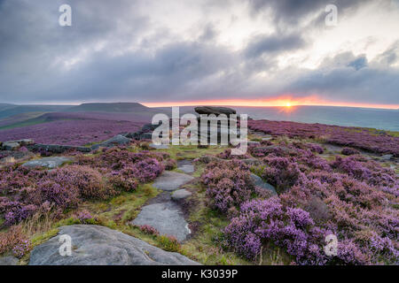 Stürmische sunrise an über Owler Tor in Derbyshire, mit Blick auf Winyards Nick Higger Tor in der Ferne Stockfoto